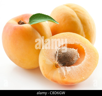 Apricots with leaves on a white background. Stock Photo