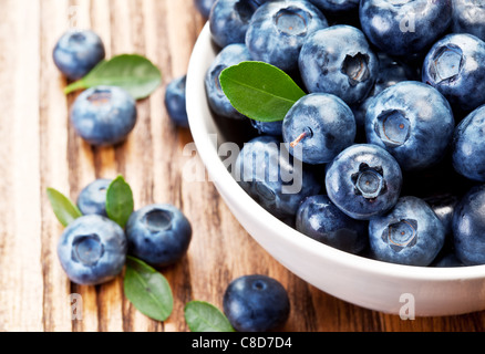 Blueberries in a bowl on a wooden table. Stock Photo