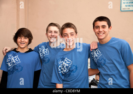 young person people Four teen boys in the Lion's heart Boys Club Hanging out smile for camera. Inside editorial only.  12-14 year old olds  © Myrleen Stock Photo