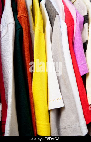 Multi colored shirts on hangers. Stock Photo