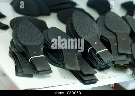 Black shoe soles in a factory Stock Photo