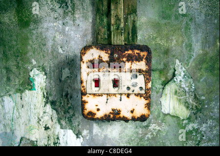 A rusting electrical socket on the wall of a derelict cottage on the Shetland Islands, Scotland. Stock Photo