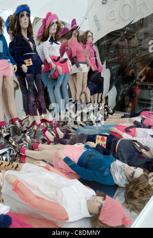 Women’s fashion shop window display consisting of mannequins reflected in a mirror Stock Photo