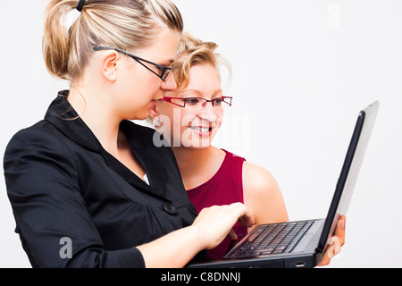 Two young business women with laptop. Stock Photo