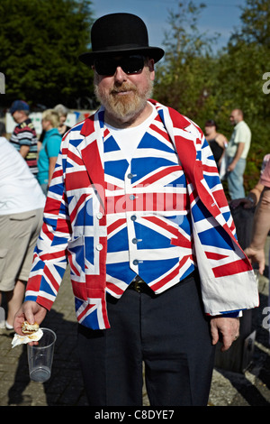 English eccentric wearing a Union Jack waistcoat and jacket complete with Bowler Hat. England, Europe. Eccentric UK Stock Photo