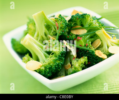 Steam-cooked broccoli with thinly sliced almonds Stock Photo