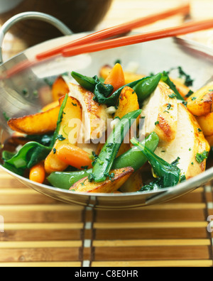 Chicken and spring vegetables cooked in a wok Stock Photo