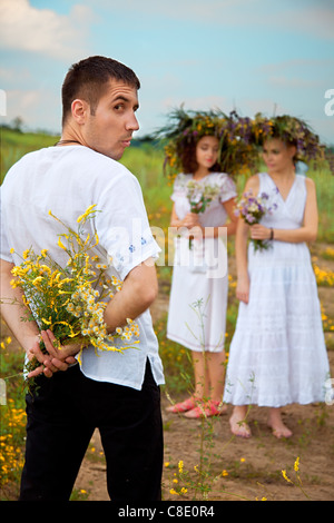 difficult choices. man and two womans. outdoor shot Stock Photo