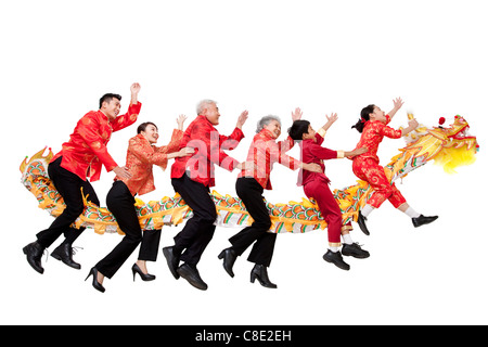 Family Dressed in Traditional Clothing Riding a Chinese New Year Dragon