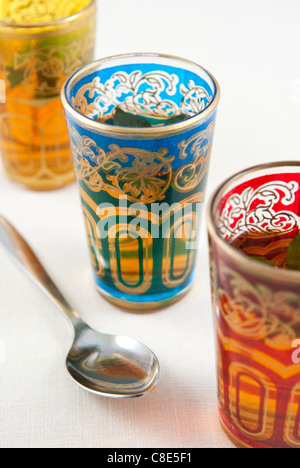 Small coloured glasses of mint tea on a white background. Stock Photo