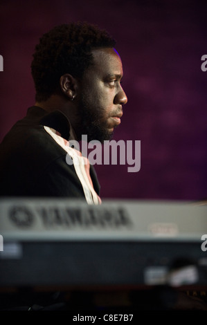 Robert Glasper playing keyboards on stage with his band the Robert Glasper Experiment at Brecon Jazz Festival 2011 Stock Photo