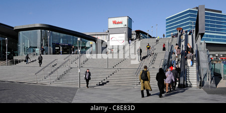 London street scene multicultural people using steps & escalator to Stratford London train station & Westfield shopping centre & office building UK Stock Photo