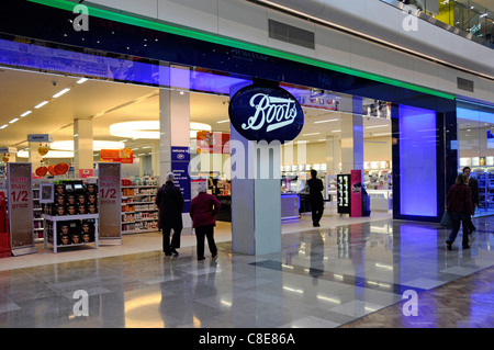 People in Boots pharmacy chemist beauty shop front & shoppers entrance Westfield shopping centre mall in Stratford City East London Newham England UK Stock Photo