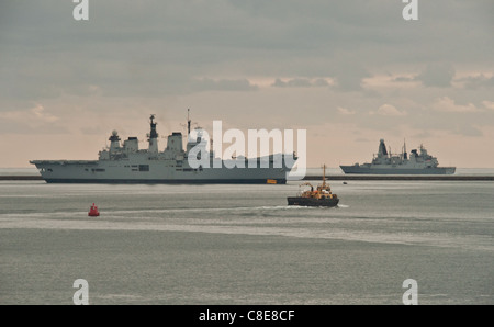 HMS Illustrious in Plymouth sound with a Royal Navy Daring Class destroyer in the background. Stock Photo