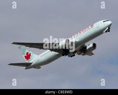 Air Canada Boeing 767-300ER passenger jet plane climbing on takeoff and retracting its undercarriage Stock Photo