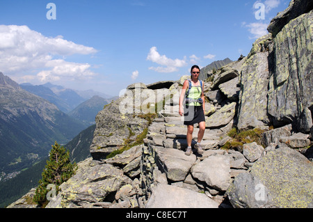 A young woman walker on a footpath in the French Alps Stock Photo