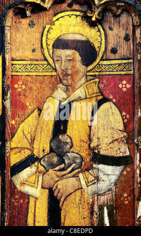 Ludham, Norfolk, rood screen, St. Stephen with stones of martyrdom male saint saints English medieval screens painting paintings Stock Photo
