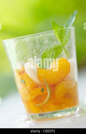 Yellow and white peach salad with fresh mint Stock Photo