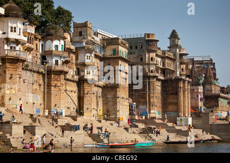 Indian Hindu pilgrims bathing in The Ganges River at Ranamahal Ghat and Chousatti Ghat in Holy City of Varanasi, India Stock Photo