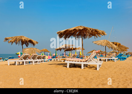 horizontal Calangute beach scene loungers shacks sand sun parasols beach sea blue skies crop margins copy space empty spaces Stock Photo