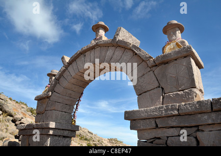 Traditional Arch made of Stones on Taquile Island with Blue sky in the background Stock Photo