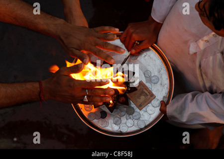Priest and devotee performing aarti, Haridwar,Uttarakhand, India Stock Photo