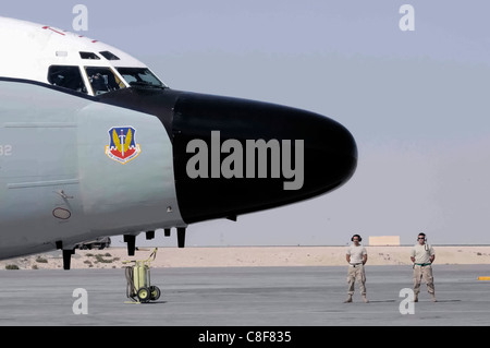 Airman 1st Class Dock Caudhill and Staff Sgt. Casey Bode stand by for an RC-135 Rivet Joint Stock Photo