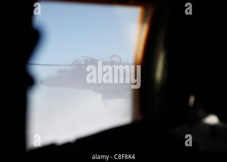 A Marine Corps AV-8B Harrier links with a KC-130J Hercules at high speeds in skies of Afghanistan. Stock Photo