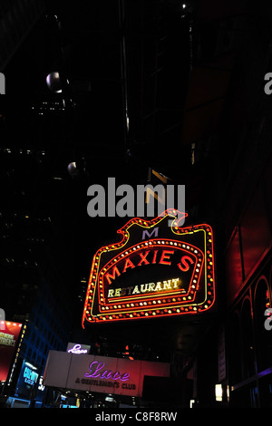 Night portrait red yellow neon Maxie's Restaurant sign and Lace Gentlemen's Club sidewalk canopy entrance, 7th Avenue, New York Stock Photo