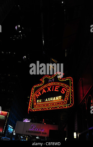 Night portrait illuminated red yellow neon Maxie's restaurant sign sidewalk canopy Lace Gentlemen's Club, 7th Avenue, New York Stock Photo