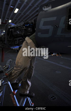 A Marine serving with the 11th Marine Expeditionary Unit maintains an AV-8B Harrier Stock Photo