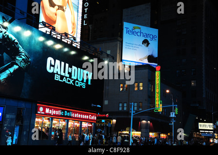 Night-time view billboards, sidewalk people, red Majestic Cafe, neon Applebees sign, 7th Avenue West 50th Street, New York Stock Photo