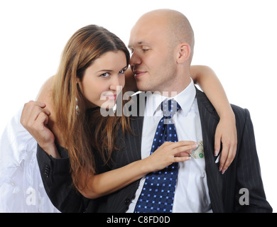 Woman pulls money out of pocket businessman Stock Photo