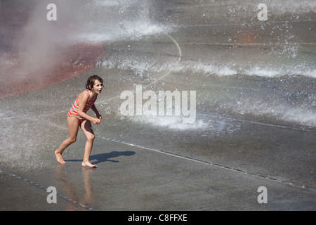 A young girl plays in the fountain at Bumbershoot. Stock Photo