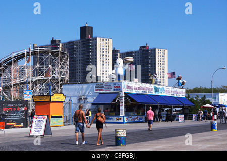 Coney Island boardwalk in the early Fall season with the famous Cyclone roller coaster in background Stock Photo