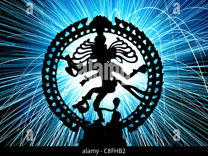 Dancing lord Shiva statue, Nataraja, in front of fireworks sparks. Silhouette Stock Photo