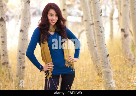 A young Latina / Native American female posing under the trees. Stock Photo