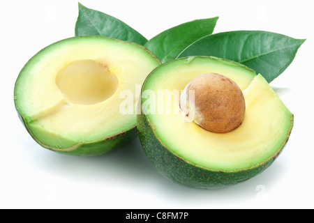 Ripe avocados with leaves on a white background. Stock Photo