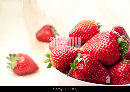 Appetizing strawberry in the bowl. Isolated on a white background. Stock Photo