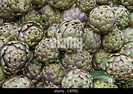 Artichokes displayed in stall at street market show Italy Italian Mediterranean Stock Photo