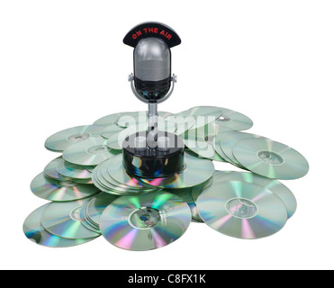 Saved broadcasts shown by a retro pill audio microphone on a pile of disks - path included Stock Photo