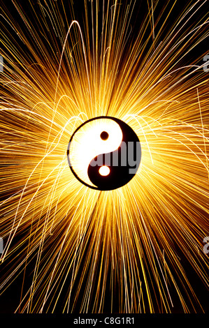 Yin Yang in front of firework sparks. Silhouette Stock Photo