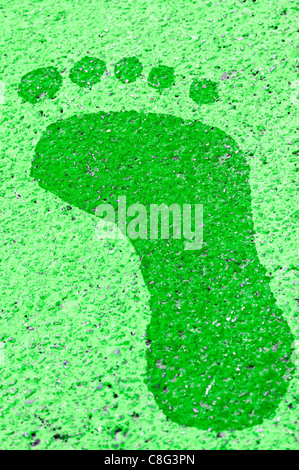 A green footprint painted onto a pavement Stock Photo