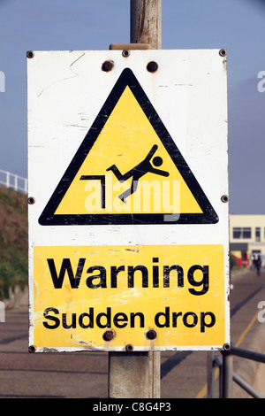 graphic public sign reading - Warning Sudden drop, Southwold, Suffolk, UK Stock Photo