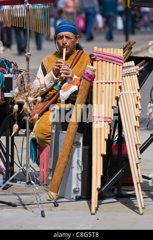 Peruvian musicians play pan pipes busking in Salisbury and playing their music to shoppers Stock Photo