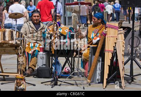 Peruvian musicians play pan pipes busking in Salisbury and playing their music to shoppers Stock Photo