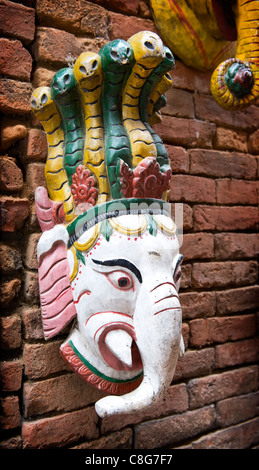 Wooden painted carved masks of the Elephant God Ganesh hang from a stall in Bhaktapur, Nepal, Asia Stock Photo