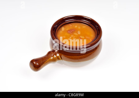 Ham & bean soup in a crock on white background, cutout. Stock Photo