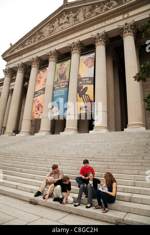 Teenagers sitting outside the front of the national Archives building, Washington DC USA Stock Photo