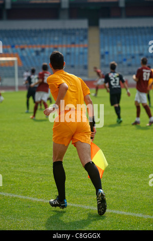 Football linesman referee holding flag Stock Photo